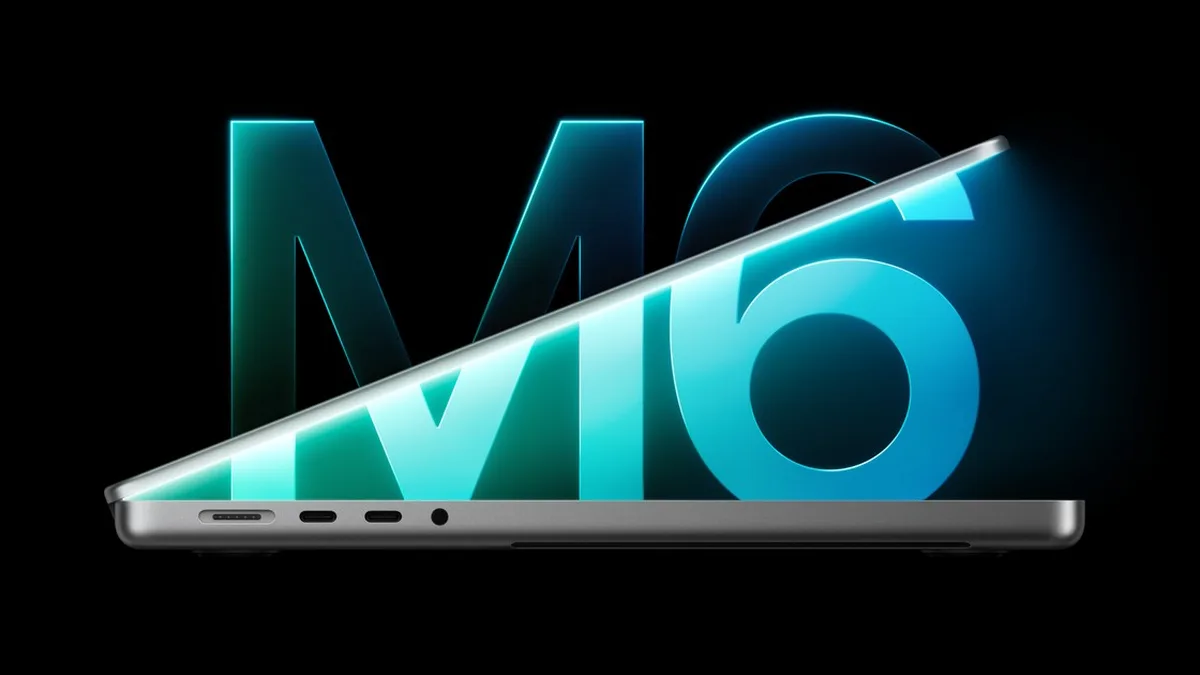 MacBook Pro deschis, văzut din profil, în fața inscripției mari „M6”