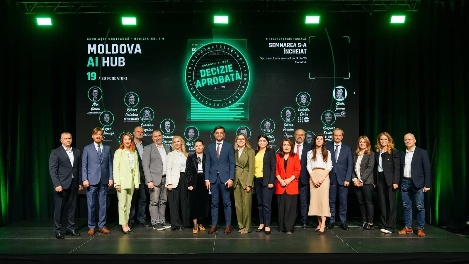 Fondatorii Moldova AI Hub pe scenă, în fața unui ecran cu inscripția „Moldova AI Hub – Decizie aprobată”