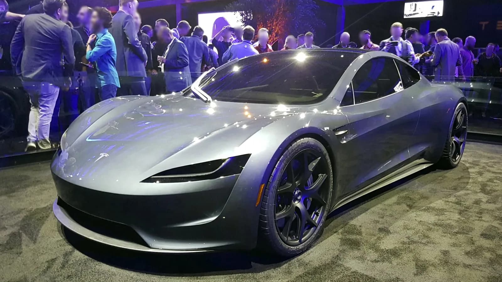 Prototipul Tesla Roadster de culoare gri, expus la lansarea din 2017, înconjurat de vizitatori